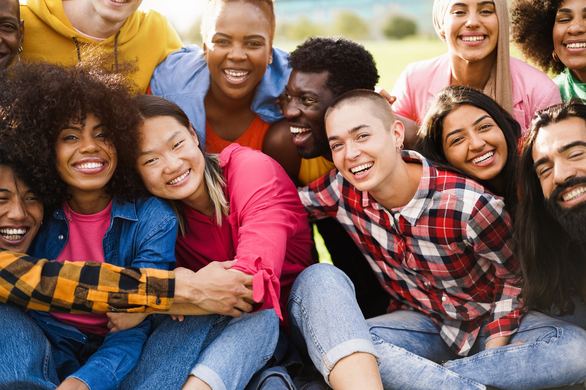 Young diverse people having fun outdoor laughing together - Diversity concept - Main focus on bald girl face